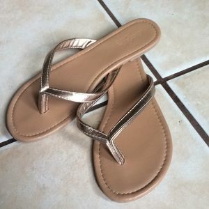 Metallic gold flip flops